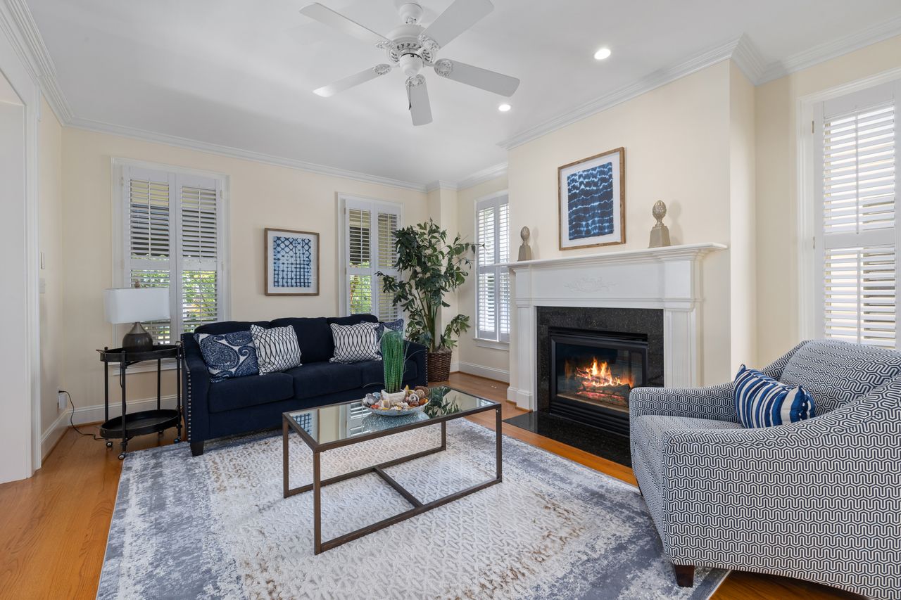 A beautifully designed living room featuring a fireplace, elegant furniture, and modern decor elements.